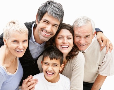 Portrait of a cheerful boy with loving parents and grandparents