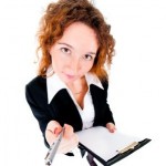 Businesswoman holds out a pen Businesswoman holds out a pen