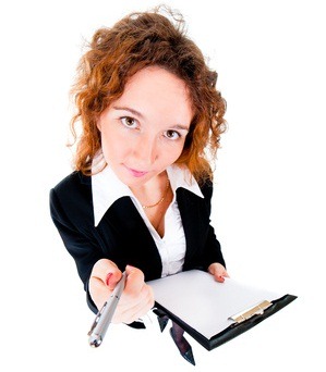 Businesswoman holds out a pen